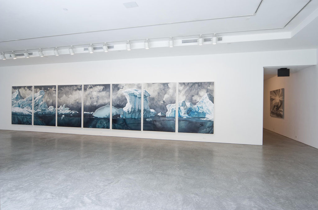 Seven panel painting of the ocean in gallery space