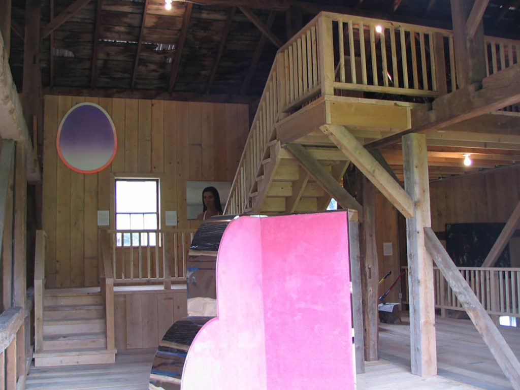 view of pink sculpture and paintings inside barn