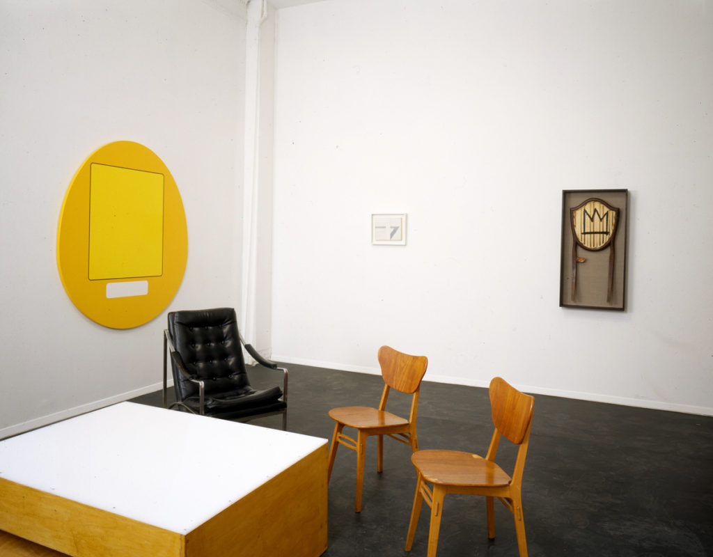 Sculptures and chairs in gallery