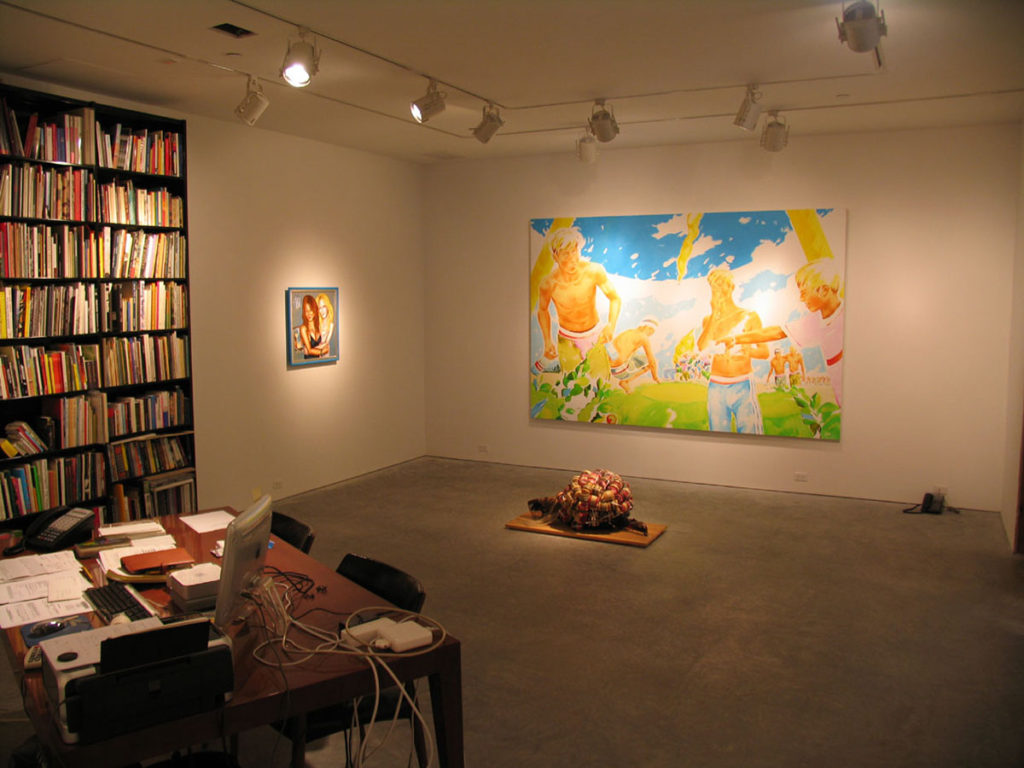 paintings and sculptures in gallery office space, large bookshelf