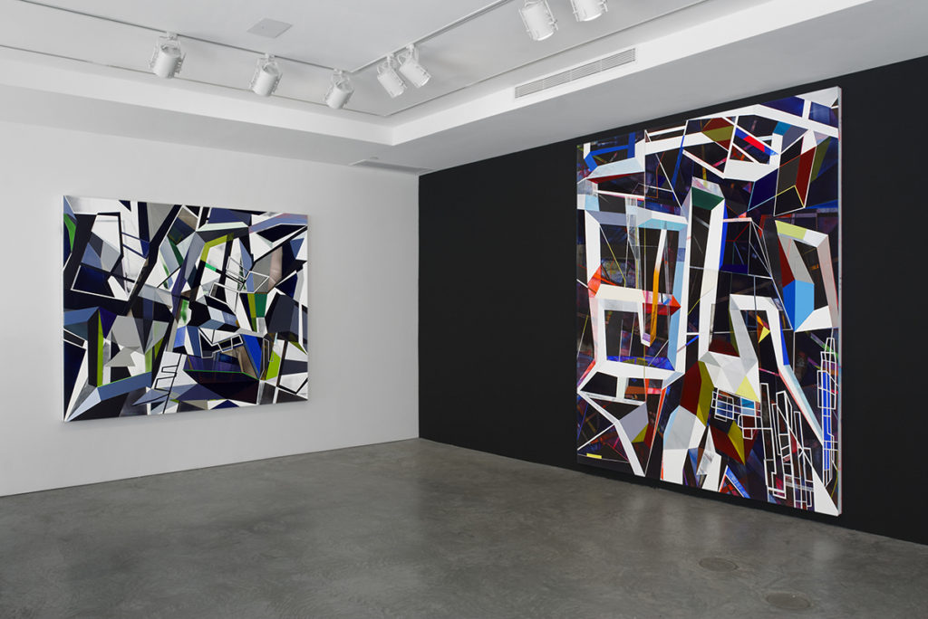 Geometric paintings in gallery on black wall