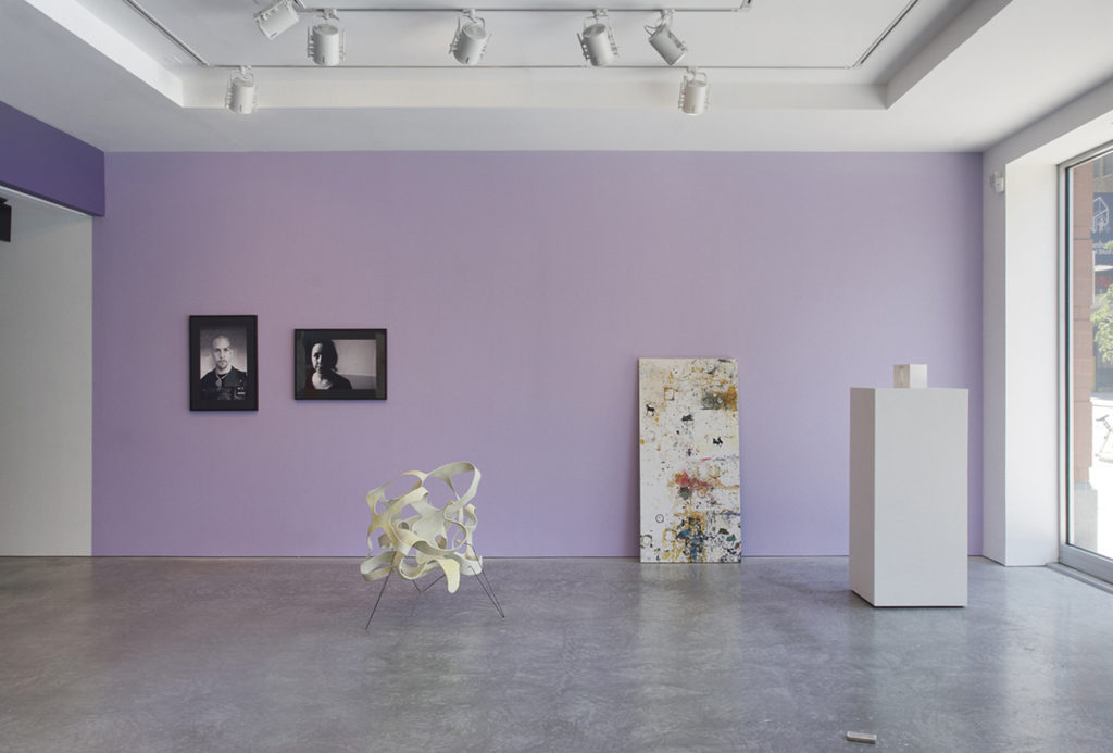 Artworks in gallery with purple wall