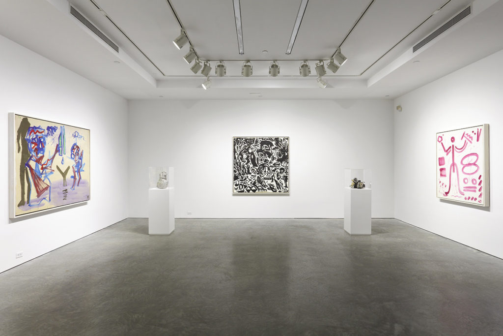 paintings in a gallery and sculptures on pedestals