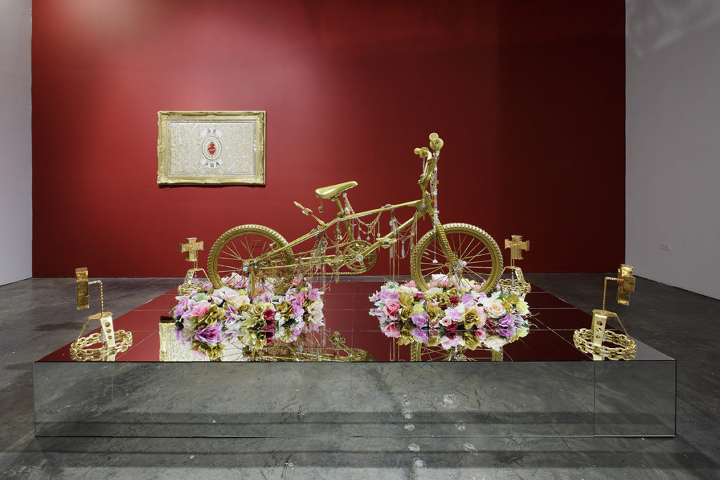 sculpture of a gold bike with flowers