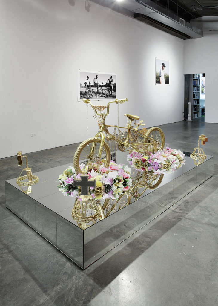 sculpture of a gold bike with flowers,