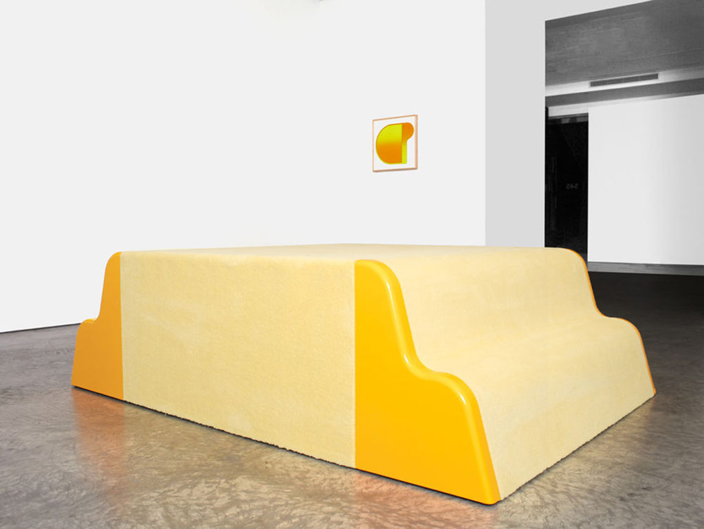 large yellow sculpture and small painting in gallery