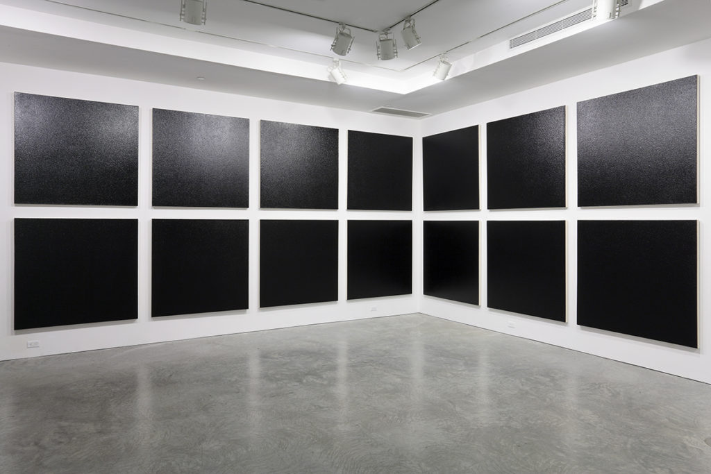 black paintings in a gallery