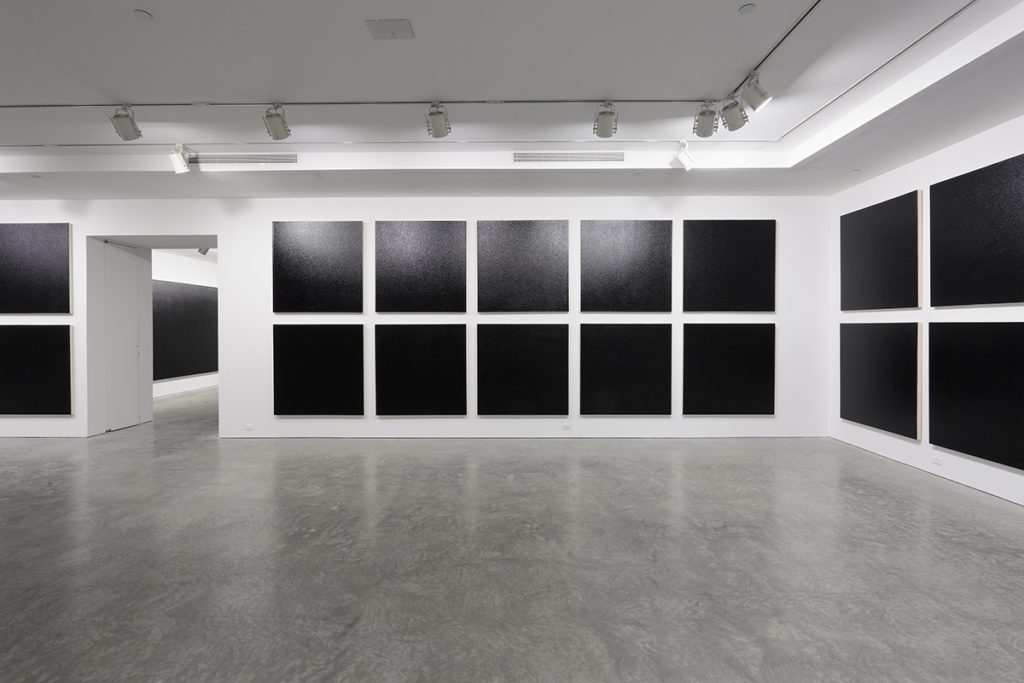 black paintings in a gallery