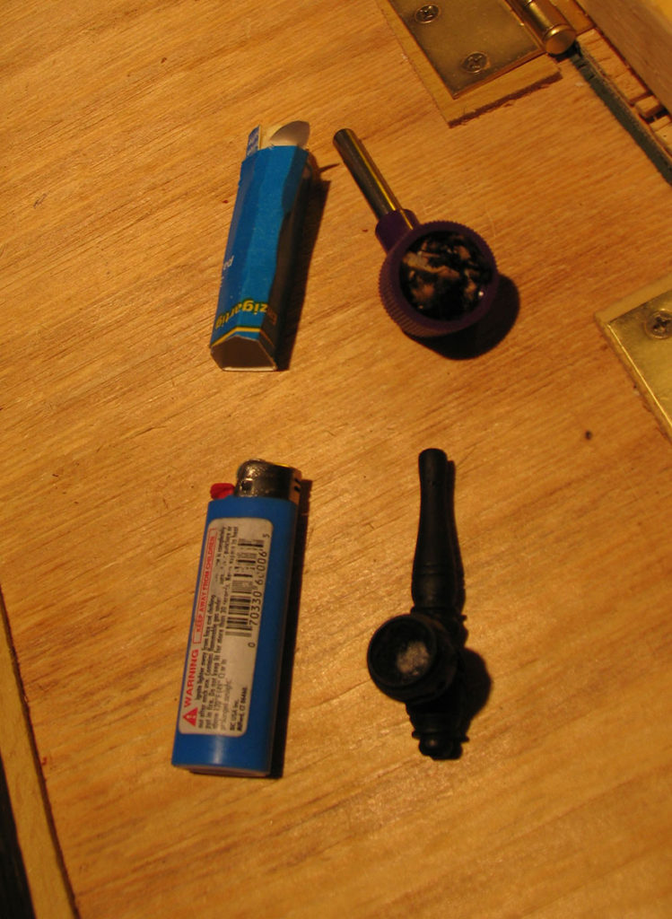 Lighter and pipe on table